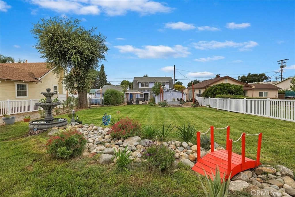This spacious 2-story home is ready for you to move right in. Conveniently located on a quiet well-kept street close to all your favorite downtown spots. This 3 bed and 2 bath home offers plenty of space for the family and all your vehicles. The home sits well back off the street offering a beautifully landscaped large front yard area with lush green grass, various trees, fire pit, a beautiful fountain, and even an above-ground pool area. There are two separate drives and a large carport offering plenty of vehicle parking or storage. The oversized garage with separate workshop has been partially finished with drywall and updated lighting and outlets. Inside the home you will find the newly completed vinyl plank flooring throughout the home. The large kitchen with plenty of bar seating is open to the family room and designed around a wood burning brick fireplace. There is a large bonus room downstairs, with a wood burning stove, that can be the 3rd bedroom, an office, den, or whatever you desire. There is a 3/4 bath downstairs in addition to a separate and spacious laundry room. Upstairs you will find 2 additional bedrooms and a full bath with a newly installed soaking tub/shower. This great home has so much to offer and the location is very convenient and commuter friendly. Low tax rate and No HOA!!! Don't let this one slip away!