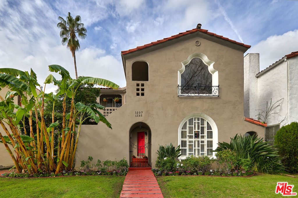 Welcome to this charming Spanish home situated in the heart of highly coveted Carthay Square. Enter past the gated courtyard with manicured landscaping to discover a spacious and open floor pan that is beautifully accented by gleaming wood floors and grand windows welcoming floods of natural light within. Relax in the inviting living room with a decorative fireplace and beautiful glass stained window. Additional features include fully equipped kitchen, expansive primary suite, formal dining, breakfast alcove with built-ins, in-unit laundry, and more. A serene grassy yard offers ample patio space for lounging, entertaining, and dining al-fresco.