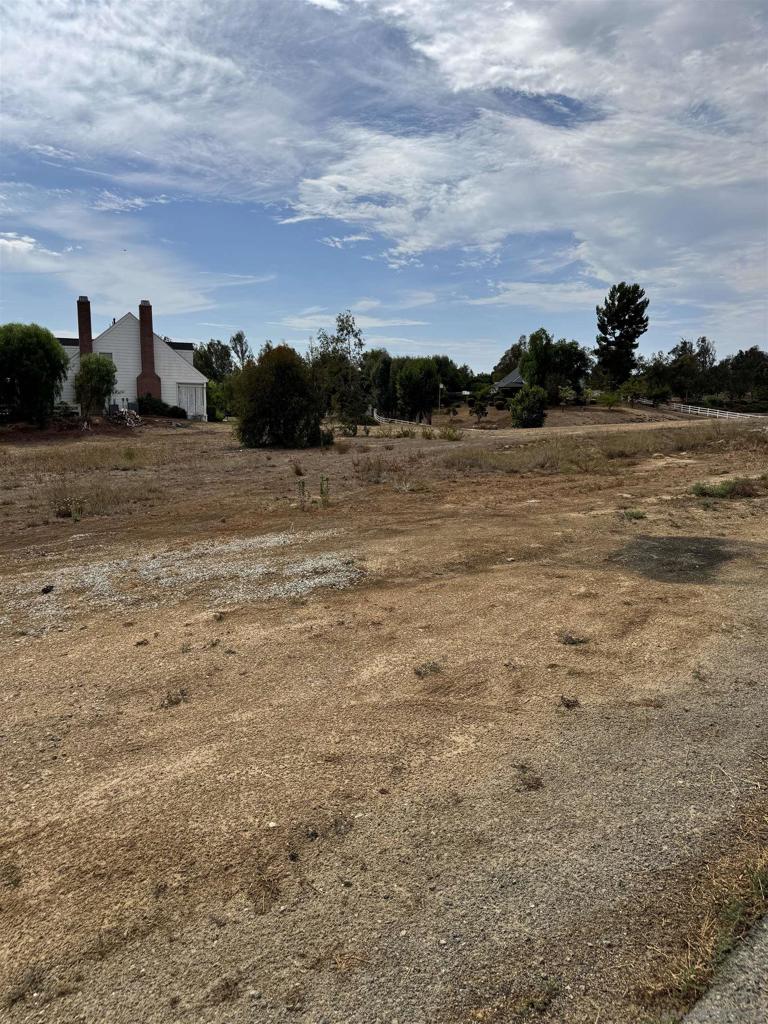 An extraordinary opportunity awaits in the heart of Temecula—your chance to own the very last .92-acre residential lot in this coveted in-town location. Flat, fully usable, and ready to build, this rare parcel already has water, electricity, and phone/internet on site, making it the perfect canvas for your custom dream home. Few properties offer this much space within city limits, especially with gentle terrain and open views that capture Temecula’s beauty. Wake up to golden sunrises, unwind with colorful sunsets, and watch hot air balloons drift across the sky—all from your own backyard. With paved roads, nearby utilities, a low tax rate, and no HOA, the value here is unbeatable. Best of all, you’re just minutes from Wine Country, Old Town Temecula, top-rated schools, shopping, dining, and freeway access. Positioned at the corner of Green Tree Rd. and Via Telesio, this one-of-a-kind property won’t last long—don’t miss your chance to make it yours.