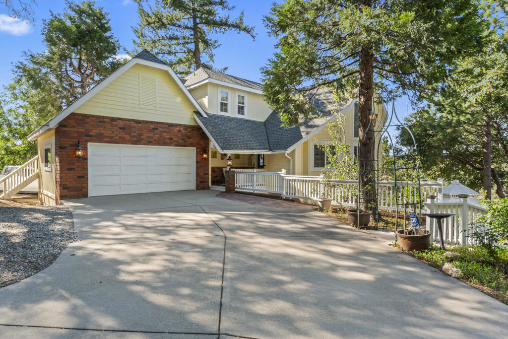 Welcome to your picture-perfect Lake Arrowhead escape, where classic cottage charm meets modern comfort and luxurious details. This beautifully maintained home is in immaculate condition, offering a peaceful, landscaped setting complete with a garden gazebo and tranquil water feature. Enjoy lake views--including front-row seats to the Fourth of July fireworks--from multiple vantage points. Inside, the home features a step-down living room with vaulted ceilings, a warming gas fireplace. The private upper-level primary suite offers a relaxing retreat with a walk-in cedar-lined closet and serene panoramic views. The chef's kitchen boasts wood flooring, high-end appliances, granite counters, and everything you need to entertain in style. Downstairs, a game room with fireplace and wet bar creates the perfect hangout space, while a workshop awaits hobbyists and DIY enthusiasts. Thoughtful extras include energy-efficient and water-wise systems, ample storage, parking for up to 10 cars, and level entry for easy access. The paved private road and gated entry, maintained by local homeowners, ensures both privacy and convenience. Plus, it's centrally located to enjoy all that Lake Arrowhead has to offer. Sold furnished, this turnkey home is ready for you to move in and start living the Lake Arrowhead lifestyle.