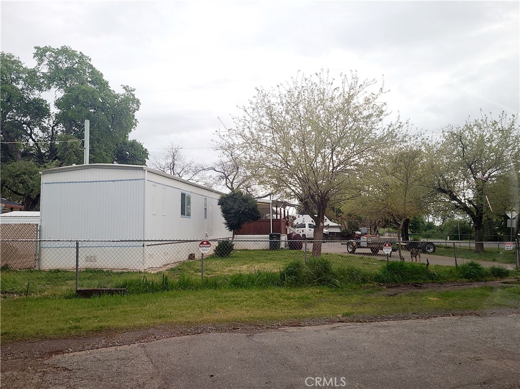 Nice 0.21 acre corner lot in Central Oroville with a 2 bedroom, 2 bathroom manufactured home on permanent foundation! The property offers a fully fenced yard with gated driveway, detached garage/workshop, and shed for additional storage. Enjoy the privacy of no neighbors across the street as you relax on the solid wood covered porch, perfectly positioned for stunning West-facing sunset views. A great opportunity for buyers seeking space and functionality, either for personal use or as a rental property, in a prime location!
