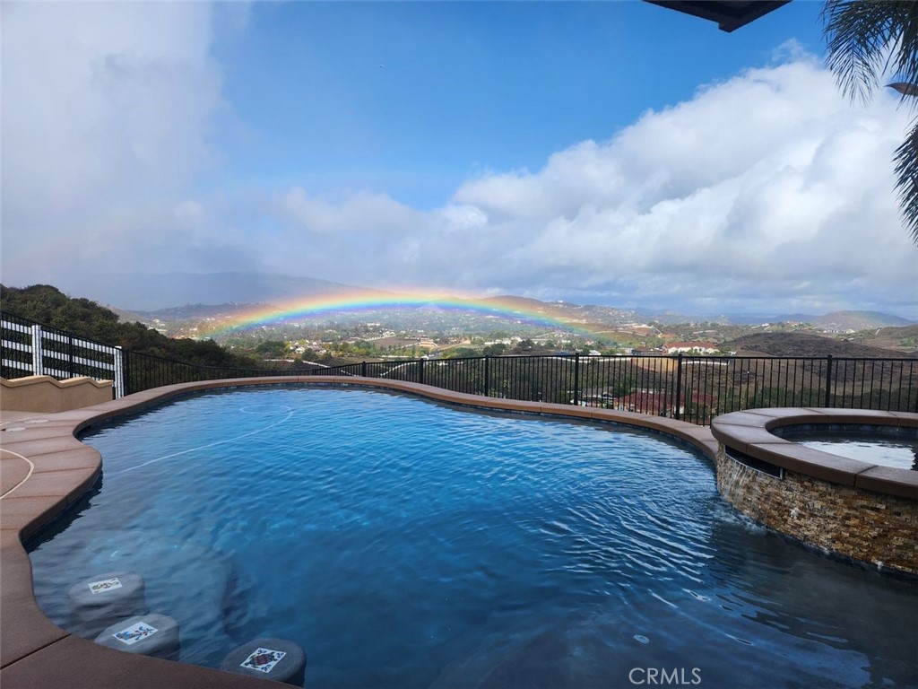 Single story La Cresta home close to the entrance! Experience unparalleled luxury in this meticulously maintained Mediterranean-style estate, boasting breathtaking panoramic views. Recently upgraded kitchen, vaulted ceilings and an open floor plan, this home is perfect for grand entertaining. Enjoy state-of-the-art amenities including a security system, intercom-speaker system, and a great room with a cozy fireplace. Supersized gourmet kitchen with new granite countertops and sleek tile flooring. The expansive master suite offers stunning city light views, complemented by a spacious main bathroom with a spa like tub. The property has areas ideal for horses, workshop, barn or toys. Step outside to your private oasis—a luxurious pool & spa, perfect for relaxing or hosting lavish gatherings. This property boasts some of the best views in La Cresta. You will have to come see for yourself. Private gated entry, citrus trees including orange, lemon & lime. One acre of Avocado trees.There’s plenty of space and flat land to add equestrian facilities, a guest house, ample parking, or simply enjoy the open space and tranquility. La Cresta is known for its peaceful, upscale living, and this property embodies that lifestyle. With breathtaking sunsets, mountain views, and ample room to roam, this estate offers a unique opportunity to live in harmony with nature—without sacrificing comfort or sophistication. Adjacent to La Cresta lies the Santa Rosa Plateau, a protected ecological reserve encompassing approximately 9,000 acres of preserved land. This sanctuary safeguards diverse ecosystems and local wildlife. The Santa Rosa Plateau’s commitment to conservation ensures that these landscapes remain undisturbed, offering a peaceful retreat and a glimpse into California’s natural heritage. Come see what La Cresta has to offer with nearby hiking, biking & horse trails.