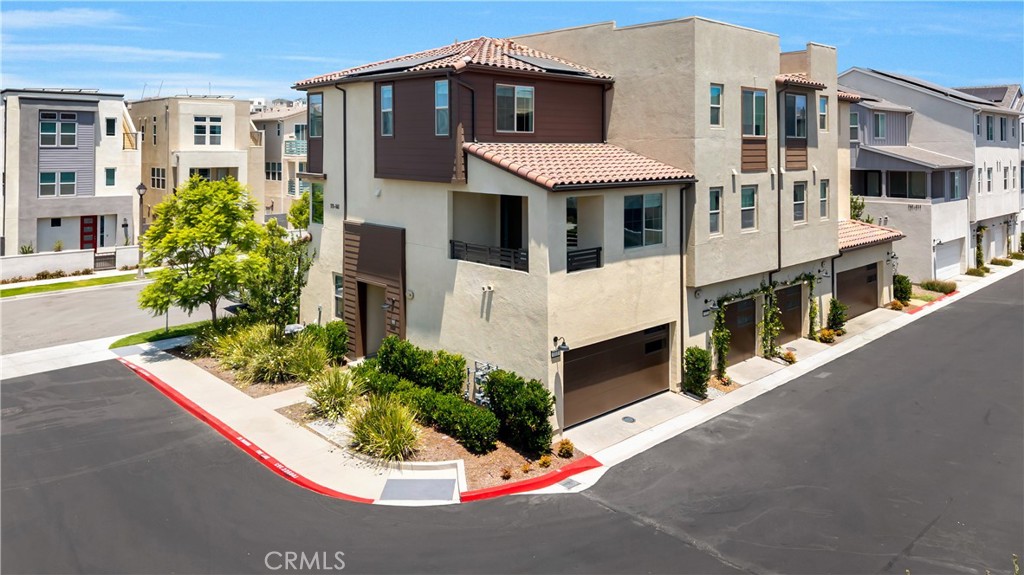 Welcome home to 111 Juniper Drive in the Oasis neighborhood of Rienda, part of the award-winning community of Rancho Mission Viejo! This designer-upgraded end-unit home offers 2 bedrooms, 2.5 bathrooms, plus a loft, and is situated in one of the best locations in the neighborhood. With only one shared wall, it lives like a single-family home and allows for an abundance of natural light. Featuring over $45,000 in upgrades, this home includes luxury vinyl plank flooring, upgraded floor tile, Roman shades, and stylish light fixtures. On the first level, you’ll find a bedroom with an en-suite bathroom, featuring a walk-in shower and glass sliding doors that lead to a private patio. Upstairs on the second level, enjoy an open floor plan with a dining area highlighted by a stunning chandelier and large windows showcasing beautiful views of Boulder Pond. The kitchen boasts an oversized island with quartz countertops, soft-close shaker cabinets, a ceramic tile backsplash, and stainless-steel GE Profile appliances. Relax in the cozy living room with direct access to the balcony — perfect for morning coffee or evening sunsets. Just off the kitchen is a conveniently located powder room, ideal for guests. A versatile loft on the third level also offers views of Boulder Pond and is perfect for a home office or can be converted into a third bedroom. Retreat to the primary suite, complete with chandelier lighting, a custom walk-in closet, and a generously sized bathroom with a dual-sink vanity, a walk-in shower with ceiling-high subway tiles, bench seating, and a TOTO heated bidet toilet seat. Also on this level is a separate laundry room with a stackable washer and dryer, as well as a hanging rack. Additional highlights include a two-car attached garage with epoxy flooring, overhead storage racks, added lighting, and a solar system. Ample guest parking is available, and the home is just a short walk to Boulder Pond, a playground, and Ranch Camp. Enjoy the exceptional amenities that Rancho Mission Viejo has to offer, including multiple resort-style pools, fitness centers, parks, sports courts, an arcade, a dog park, hiking trails, and so much more!
