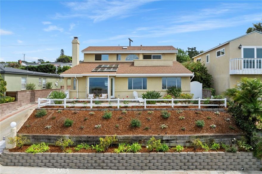 On a quiet street in the upper Hollywood Riviera, this bright and airy residence captures breathtaking views of the ocean, sparkling city lights, and the iconic Queen’s Necklace coastline. Expansive windows showcase the scenery from nearly every room—including the living and dining areas, open-concept kitchen, and the luxurious primary suite with its own private balcony and retreat. Thoughtfully placed skylights bathe the interiors in abundant sunshine and natural light.

Offering five spacious bedrooms plus two additional rooms ideal for offices or hobby spaces, the home provides both versatility and comfort—all enhanced by sweeping ocean vistas. The lower level includes three generously sized bedrooms and two full baths, while the upper level is dedicated to the primary wing. Here, panoramic views can be savored from both the bedroom and spa-inspired bath, while a private retreat overlooking the ocean offers the perfect place to relax.

Out back, a tranquil garden with fruit trees creates a peaceful escape. All of this is just moments from the beach, award-winning schools, and the charming Riviera Village with its restaurants and boutique shops.