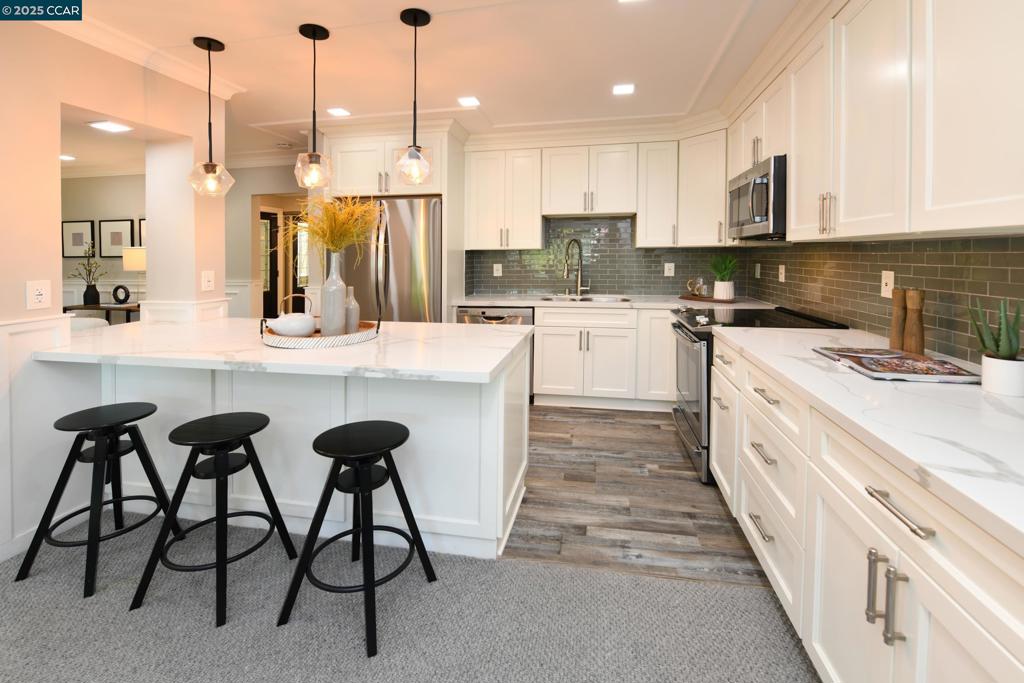 STUNNING COMPLETELY REMODELED SEQUOIA MODEL WITH SO MANY HIGH END UPGRADES. WHITE CABINETS, STAINLESS APPLIANCES, QUARTZ COUNTERS, EXTENDED CABINTRY/COUNTERS, WINE REFRIGERATOR, SS APPLIANCES, LUXURY VINYL PLANK FLOORING & AUSTRALIAN WOOL BERBER CARPET. ELECTRIC FIREPLACE, CROWN MOULDING & WAINSCOTING, DUAL PANE WINDOWS/DOOR, LEADED GLASS FRONT DOOR, PLANTATION SHUTTERS & SILHOUETTE BLINDS, CLOSET ORGANIZERS, MIRRORED DOORS. REMODELED BATH WITH LARGE SHOWER. FULL SIZE WASHER/DRYER INCLUDED. TRULY METICULOUS & BEAUTIFUL DETAIL THROUGHOUT.
