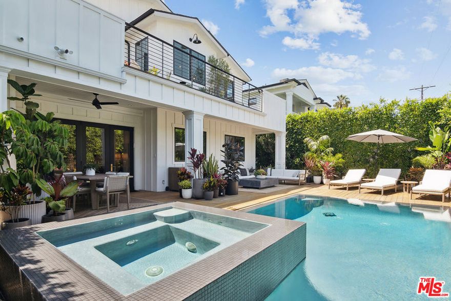 Modern Farmhouse located in the Melrose District of Los Angeles, near the West Hollywood border. Built in 2016 and updated in 2023, this 5-bedroom, 5.5-bath residence blends traditional architecture with modern comfort.The main level features a chef's kitchen with Sub-Zero and Wolf appliances, marble counters, dual dishwashers, and a large island that opens to the living area and backyard. Additional spaces include a home office, media/theater room, formal dining room, and one ensuite bedroom.Upstairs offers four additional ensuite bedrooms, including a primary suite with private terrace, fireplace, and spa-style bath.Outdoors, enjoy a heated pool and spa, mahogany deck, outdoor fireplace, and multiple lounge areas surrounded by mature landscaping. Other highlights include two indoor fireplaces, whole-home audio, electronic window coverings, water-filtration and softener systems, and a two-car garage currently used as a gym. Gated parking and a private backyard complete this modern retreat near the best of Melrose and Fairfax.