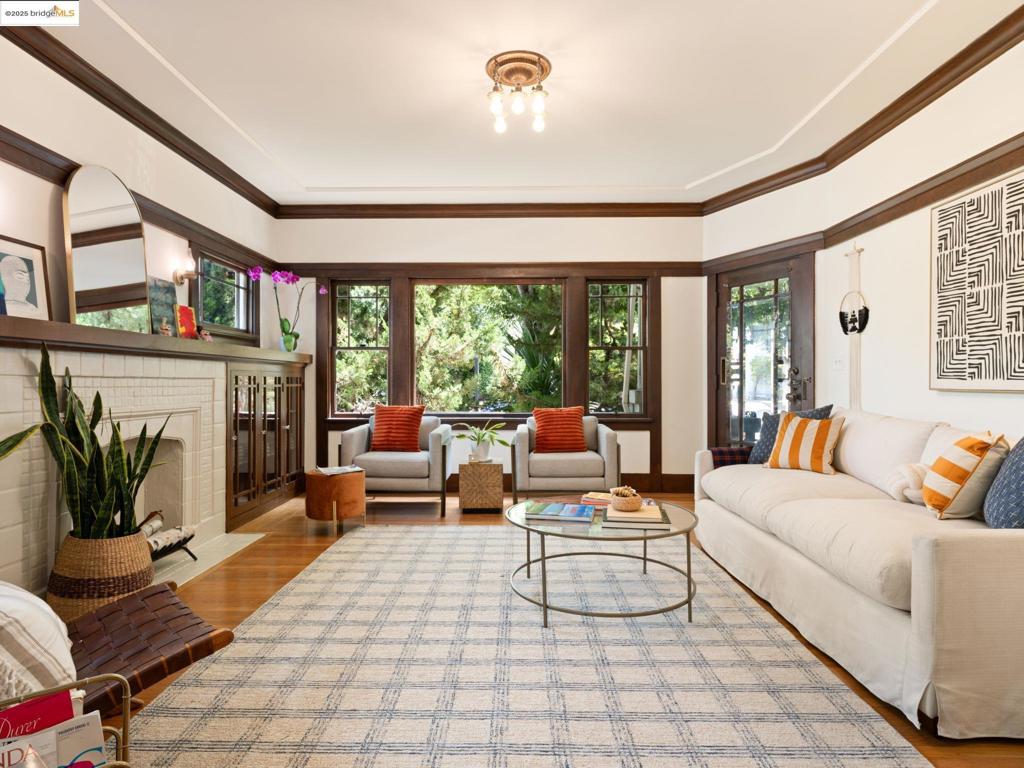 Tucked into a tree-lined street in one of Berkeley’s most coveted neighborhoods, this exceptional one-bedroom condo occupies the lower level of an intimate four-unit 1924 building—a blend of historic charm and elevated living. Gracious in scale and rich in detail, the home features a formal dining room, spacious living room with a decorative fireplace, and period craftsmanship throughout—from original built-ins to hardwood floors and soaring recessed ceilings. The bright bedroom offers peek-a-boo Bay views, while the thoughtfully updated bath and powder room add a modern touch to classic design. The kitchen is generous and ready for your touch. In-unit laundry, abundant basement storage, and garage parking provide the practical luxuries, while the location seals the deal: just one block to the shops, restaurants, and farmers’ market of the North Shattuck Gourmet District, half a block from Live Oak Park, and minutes to UC Berkeley and BART. An impressive WalkScore® of 95 and a BikeScore™ of 91, this address puts the city’s best dining, culture, and green spaces at your fingertips—whether you’re strolling to brunch, cycling to campus, or savoring the neighborhood’s vibrant energy. Simplified living, low HOA, in the heart of it all, and rarely available.