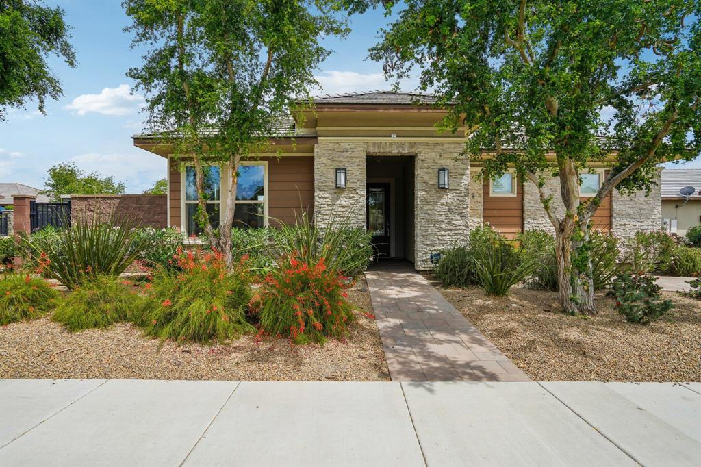 Step into refined desert living at its finest with this impeccably maintained single-family gem, nestled behind the manned-gated entrance of Trilogy Polo Club; in the All-Ages section--one of the Coachella Valley's premier resort communities. Offering 2,245 sq ft of stylishly appointed living space, this 2 bed, 2.5 bath home includes a versatile SMART room with laundry, built-in workspace, and generous cabinetry. Through a custom etched-glass door, you're welcomed into an open-concept great room showcasing designer plank flooring, crown molding, recessed lighting, and a chic TV/media niche. The adjacent flex space easily transforms into a den, office, or 3rd bedroom. Entertain with ease in the Chef's kitchen, complete with stainless steel appliances, quartz countertops, espresso cabinetry, subway tile backsplash, built-in ovens, a 6-burner gas cooktop with dramatic hood, and an oversized island with bar seating. Retreat to your sun-drenched primary suite with a spa-worthy bath featuring a soaking tub, dual quartz vanities, oversized tiled shower, and a large walk-in closet. Your guests will love the private accommodations, while the serene backyard--framed by professional landscaping, paver patios, and covered lounging areas with pocket sliders--offers the ultimate indoor-outdoor lifestyle. Just steps from world-class amenities at the clubhouse, this desert dream home is ready to impress. Schedule your private showing today!