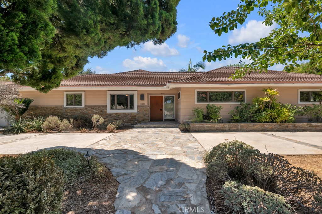 Nestled on a quiet cul-de-sac in one of Porter Ranch's most coveted neighborhoods, this expansive single-story home sits on over
16,250 sq ft of prime land and offers the perfect blend of comfort, style, and opportunity. With a little vision, this house will be the
dream home you’ve been searching for.
Step into your private backyard retreat—an entertainer’s paradise featuring a stunning pebbled saltwater pool and spa with LED
lighting, custom waterfall, pergola, cozy fire pit, and a gorgeous 14x17 post-and-beam covered pavilion with ceiling fans and three
sets of French doors. Bouquet Canyon stone carries throughout the outdoor living space into a charming indoor loggia, creating an
incredible indoor-outdoor flow.
Inside, the home boasts an open-concept living and dining area, a warm family room with two fireplaces, refinished wood
floors, smooth ceilings, and classic Terrazzo tile. The remodeled kitchen is a cook’s delight, complete with soft-close cabinetry, granite
countertops, stainless steel appliances & vent hood, and a sunny breakfast area. A spacious laundry room with ample storage
adds extra convenience.
The expanded primary suite is a true haven, featuring a walk-in closet, office alcove, sitting area with backyard access, and a luxurious
en-suite bath with marble floors, dual vanities, soaking tub, walk-in shower, and custom makeup area.
Additional features include:
• Circular driveway and 2-car garage • Central air & heat • Copper plumbing • Two water heaters • Dual pane windows with Douglas
Fir trim • Spacious secondary bedrooms • Updated bathrooms • Newer variable-speed pool pump • Recessed lighting throughout
Whether you’re ready to move right in or add your own finishing touches, this rare Porter Ranch gem offers incredible value and potential. Don't miss the chance to create your dream home.