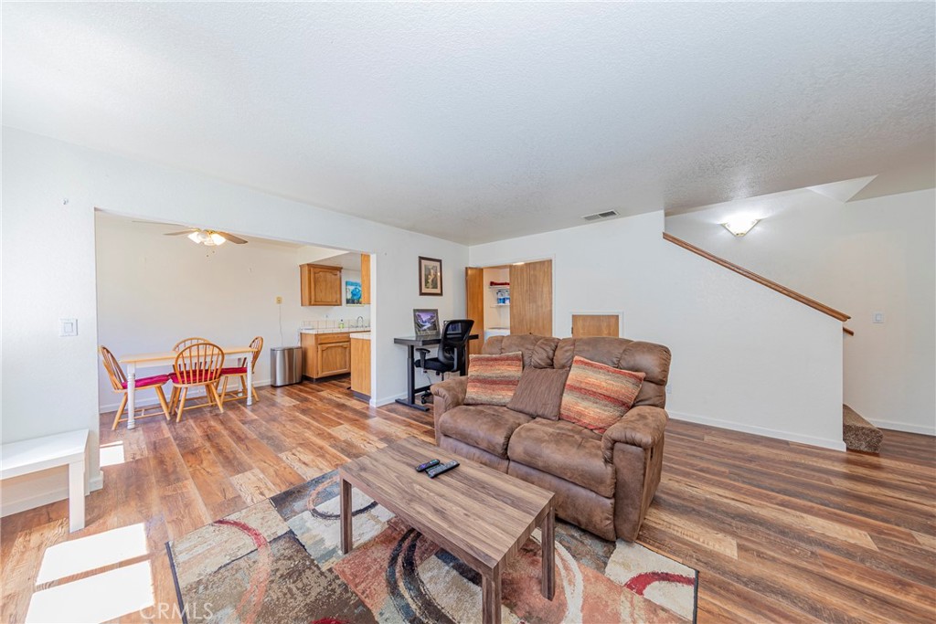 An affordable opportunity to get into your own home! A great central location is very near the town of Oakhurst and Hwy 41. Located in a gated community lined with grass areas, some covered parking and a community pool!
This functional 2 bedrooms, 1.5 bathrooms with central heating/air conditioning, has plenty of windows allowing the natural light in. A perfect location with amenities for a primary or second home. Enter into beautiful newer laminate flooring, a cozy living room with a fireplace, a half bathroom, a kitchen with a dining area, refrigerator, electric range, dishwasher and pantry closet. ALL appliances, including the washer and dryer! Upstairs you will find a full bathroom and two good size bedrooms with ceiling fans. Seller financing available!