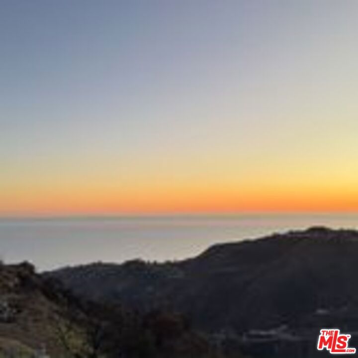 THE MALIBU MASTERPIECE YOU CAN ACTUALLY BUILD. THE HIGHEST HURDLES ARE CLEARED. THE PRICE IS IRREPLACEABLE. THE VIEWS ARE FOREVER. This is not a listing; it is the acquisition of a lifetime for the visionary developer or ultra-luxury homeowner. Presenting an EXTREMELY RARE, FULLY ENTITLED 10-ACRE coastal jewel, commanding UNPARALLELED 360-DEGREE PANORAMIC PACIFIC OCEAN VIEWS from the coveted Malibu/Topanga crest. There is genuinely NOTHING else like this on the market. The Permit Nightmare is OVER. Construction is IMMINENT. Forget years of regulatory gridlock. The current owner has done the impossible, eliminating the highest barriers to entry in coastal California. This site is DE-RISKED AND SHOVEL-READY in mere months. ALL ESSENTIAL APPROVALS ARE SECURED: California Coastal Commission (FINAL GREEN LIGHT) LA County Grading Plans, and Fire Engineering Compliance. This is a brand-new, legacy project, not a fire rebuild positioned to capitalize on a market demanding ready-to-go luxury. The property is a natural fortress, permanently buffered on two sides by PROTECTED CONSERVANCY LAND. This guarantees that your breathtaking, unobstructed vistas of the ocean and coastline will remain PRISTINE FOREVER. Accessed by a private road, this is the ultimate canvas for a secluded, masterful estate. Architectural Vision: 7,000 SF of Approved Excellence. The parcel comes with finalized, world-class plans for a 7,000-square-foot luxury compound. Designed by renowned architect Tim Gorter, a specialist in Certified Passive Homes, Fire-Engineered Structures, and LEED design. This is a blueprint for sustainable, exclusive living. Approved plans include: A versatile design (RC10-zoned) grand residence, featuring a spacious courtyard, sparkling pool and spa, three-car garage, and integrated accessory structures. 2195 E Little Las Flores Rd is more than land; it is a secured investment in a timeless California legacy. All entitlement and architectural documents are available upon immediate request. Opportunity knocks, but rarely with permits in hand. Contact the Listing Agent #1 for a private tour.
