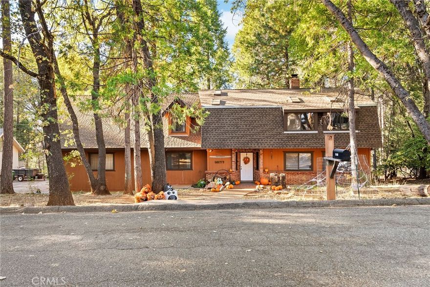 Struggling to find a home large enough to fit the entire family under one roof?  (Recently installed in 2023, the roof is brand new!)  At just under 2800 square ft., the 4 bedroom home has a striking presence from the street.  Entering the front door you are greeted with rustic charm.  Knotty pine, exposed beams, and brick all work together to create an incredible first impression.  Laminate floors and hardwood line the floor of the main living space.  The kitchen features hardwood cabinetry, stainless steel appliances, brand new cook top, and ample counter space.  Hosting large groups is never an issue.  Whether dining inside or out, the large dining space or expansive back deck will be a great place to host.  Beyond the kitchen past the laundry room, the full guest bath leads to a tucked away family room, and the expansive garage.  Inside of the garage there is an additional staircase leading to an abundance of attic storage. Heading upstairs you will find the 3 guest bedrooms, a guest bathroom, and a primary suite you will never want to leave.  Vaulted ceilings, large windows, and exposed beams create a cozy environment.  Built in linen storage, tile counters and brand new shower showcased by an over head sky light.  Overlooking the greenbelt, this large family home is perfect for the expanding family and an opportunity you shouldn't overlook!