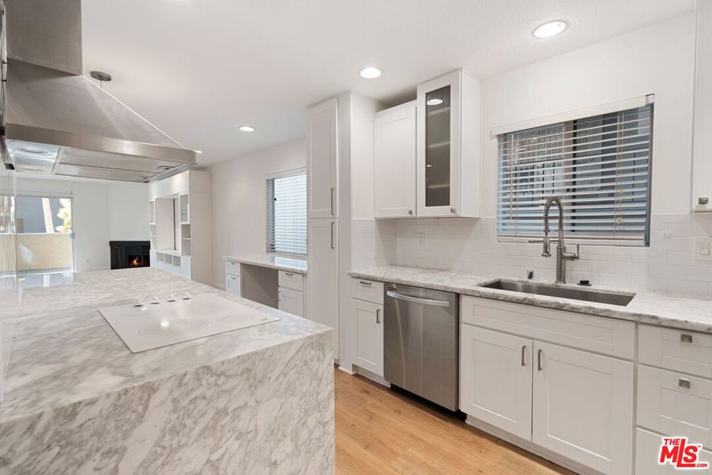 Remodeled condo in prime Norma Triangle in West Hollywood and is within close proximity to Sunset Strip! The condo has a wonderful floor plan and is designed in such a way that the living areas are in one wing of the condo, and the bedrooms, bathrooms, and the laundry area are located in the other wing of the condo. The gourmet kitchen is a stunner with its luxurious appliances and stunning countertops. The kitchen flows to the spacious living room; the living room has a fireplace and opens out to the exterior patio. The large primary bedroom suite has a showstopper of a walk-in closet and an en-suite bathroom. In-Unit Washer and Dryer! Two side-by-side parking spaces in gated garage.