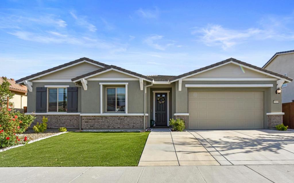 Step into this newly built single-story gem, crafted by Lennar in 2021, offering a family-friendly layout with premium upgrades. Delight in mornings on the covered patio or host gatherings effortlessly. The open floor plan, highlighted by a spacious Great Room, sets the stage for cozy movie nights. The kitchen is a chef's dream with a central island, sleek white cabinets, and dazzling quartz countertops. Rich wood flooring flows seamlessly throughout. Retreat to the luxurious owner's suite with its generous walk-in closet featuring built-in shoe shelving. The two-bay garage ensures ample storage space, or third car parking. Both front and backyard landscaping require minimal upkeep. Appliances, including a refrigerator, new washer, dryer, dishwasher, and double oven, are included.