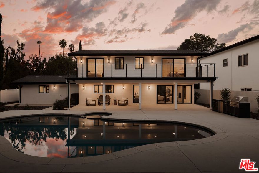 GORGEOUS MODERN FARMHOUSE IN PRIME WOODLAND HILLS. Completely renovated and beautifully designed, this stunning modern farmhouse offers an abundance of natural light and open living spaces. The main level features a spacious living room with a cozy fireplace, an elegant kitchen with a large walk-in pantry, and a family room that flows seamlessly to the backyardperfect for indoor-outdoor living. Upstairs, you'll find four spacious en-suite bedrooms, including a luxurious primary suite with a soaking tub, oversized shower, walk-in closet, and tranquil views. A convenient laundry area is also located on this level. The home has been fully remodeled, including updated systems throughout, and features a two-car garage. The expansive yard is an entertainer's dreamcomplete with a covered patio, built-in BBQ with granite countertops, and a beautiful swimmer's pool surrounded by lush greenery. Situated on a large flat lot, this property offers both privacy and style in one of Woodland Hills' most sought-after neighborhoods.