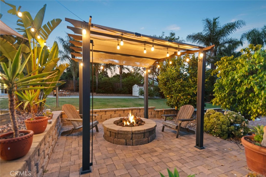 Welcome to your dream home in the heart of SE Escondido! This exceptional 3-br, 2-ba, 2,208 sqft residence sits on a peaceful, quiet street & boasts nearly 1/2 acre of beautifully landscaped outdoor space. You’ll immediately appreciate the serene neighborhood, spacious lot sizes, & mature trees that make this area truly special. No HOA/Mello-Roos! Meticulously maintained & thoughtfully upgraded, this move-in ready home offers a private sanctuary for both relaxation & entertaining. The expansive backyard features mature landscaping, raised garden beds, and 5 varieties of fruit trees—orange, mandarin, key lime, lemon, & passion fruit. There’s plenty of room to design your dream pool/spa, while existing amenities include a spacious patio for dining, a built-in fire pit, & a storage shed perfect for tools or hobby gear. The fully paid-for 35-panel (9kW) solar system delivers significant energy savings. Inside, you’ll find bamboo & tile flooring throughout, generously sized rooms, and stylish updates. The bright, open kitchen boasts white cabinetry, stainless steel appliances, a smart refrigerator, wine fridge, & a breakfast bar that connects seamlessly to the family room ideal for gatherings and day-to-day living. The primary suite offers a private retreat with sliding glass doors to the backyard, custom drapes, & chic barn doors leading to a spa-like ensuite bath with a jetted tub. 2 additional bedrooms feature energy-efficient, room-darkening shutters. A formal dining room & convenient laundry rm, with outdoor access & a tankless water heater, complete the home’s interior. With ample parking, including RV space, and a highly convenient location near the I-15, you’ll enjoy quick access to shopping, restaurants, the Safari Park, and some of San Diego’s best wineries. This home offers the rare combination of space, privacy, upgrades, and charm—a must-see in person to fully appreciate. Don’t miss your chance to own this special slice of Escondido living. Call today to schedule your private tour!
