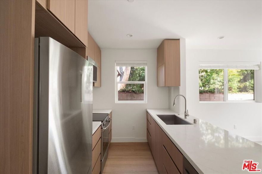 Modern ADU with Private Patio in Prime Sherman Oaks! Discover this stylish and spacious 2-bed, 2-bath detached ADU designed for modern living. Step into an open-concept kitchen and living area featuring brand-new stainless steel appliances, an extended countertop for dining or prep, and abundant natural light throughout. The primary suite offers a comfortable retreat with an en-suite bathroom, while the guest bedroom is conveniently located next to a full hall bath and in-unit stackable laundry. Enjoy your own private, enclosed patio  perfect for outdoor dining or weekend grilling. Just moments from the Sherman Oaks Galleria, Regal Theatres, Whole Foods, and easy access to the 405, this home delivers modern comfort in one of LA's most convenient locations.