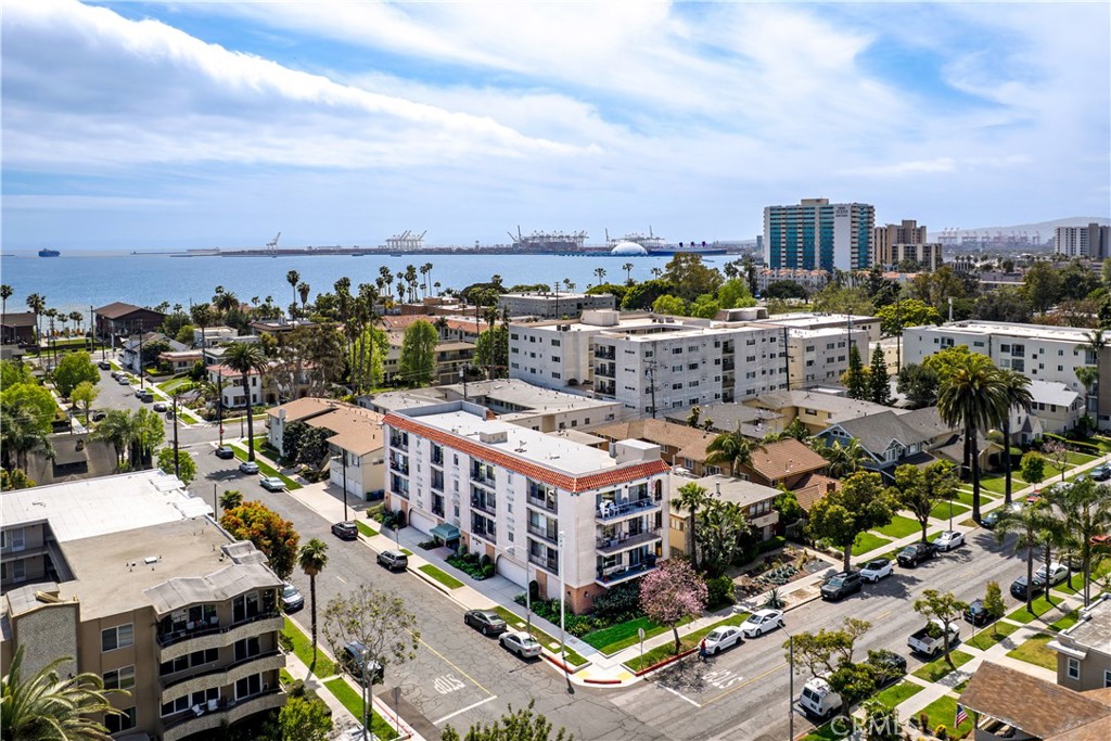 Experience coastal living in this generous size, end unit condo. If this is your first time buying or looking to downsize, take a look at this condo. Featuring 2-bedrooms, 2-bathrooms and just under 1,200 sqft of living space. With a very spacious balcony where you can truly feel the refreshing ocean breeze. This well maintained complex has only 12 units and also carries Earthquake insurance. With 2 sliding glass doors and a generous size picture window in the living room, it gives this home truly an abundance of natural light throughout the entire home and a view of the mountains and with a peek-a-boo view of the ocean and the Long Beach Museum of Art. The primary suite is complimented with beautiful wainscoting and two separate spacious closets with mirrored doors and a private en suite bathroom. The second bedroom is also a generous size room with plenty of closet space. The kitchen has tile counter tops, tile backsplash and beautiful tile floors. You'll also love the beautiful parquet wood floors and with carpet in both bedrooms. This building offers a secured lobby, elevator access, onsite laundry area and a secured parking space with an assigned storage space. This PET FRIENDLY complex is just minutes to the beach, restaurants, shops, the community farmer's market.. and situated between Belmont Shore and all the Shoreline Village entertainment. It's a must see... Don't sleep on this one!