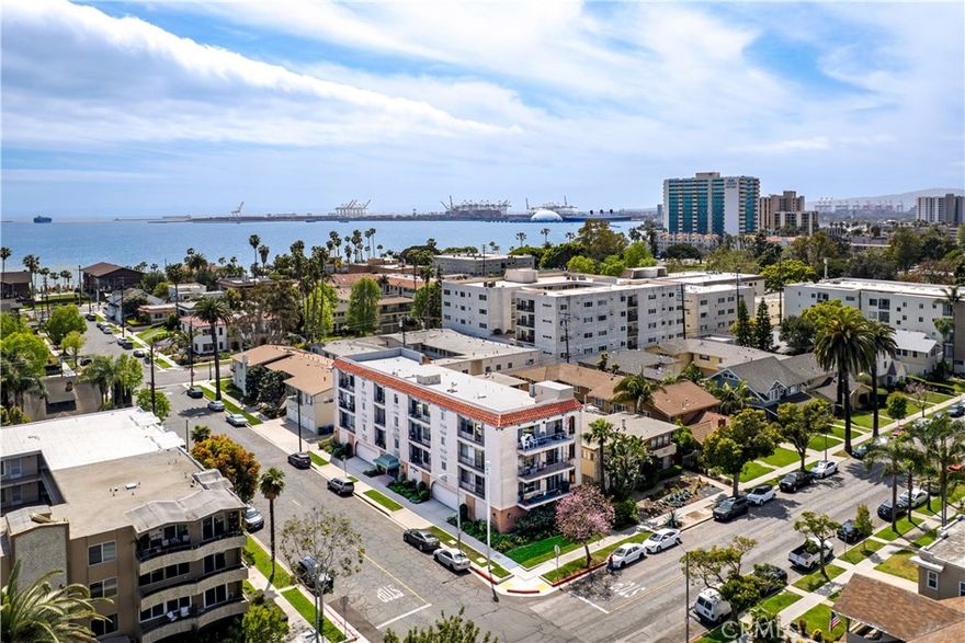Experience coastal living in this generous size, end unit condo. If this is your first time buying or looking to downsize, take a look at this condo. Featuring 2-bedrooms, 2-bathrooms and just under 1,200 sqft of living space. With a very spacious balcony where you can truly feel the refreshing ocean breeze. This well maintained complex has only 12 units and also carries Earthquake insurance. With 2 sliding glass doors and a generous size picture window in the living room, it gives this home truly an abundance of natural light throughout the entire home and a view of the mountains and with a peek-a-boo view of the ocean and the Long Beach Museum of Art. The primary suite is complimented with beautiful wainscoting and two separate spacious closets with mirrored doors and a private en suite bathroom. The second bedroom is also a generous size room with plenty of closet space. The kitchen has tile counter tops, tile backsplash and beautiful tile floors.  You'll also love the beautiful parquet wood floors and with carpet in both bedrooms. This building offers a secured lobby, elevator access, onsite laundry area and a secured parking space with an assigned storage space. This PET FRIENDLY complex is just minutes to the beach, restaurants, shops, the community farmer's market.. and situated between Belmont Shore and all the Shoreline Village entertainment.  It's a must see...  Don't sleep on this one!