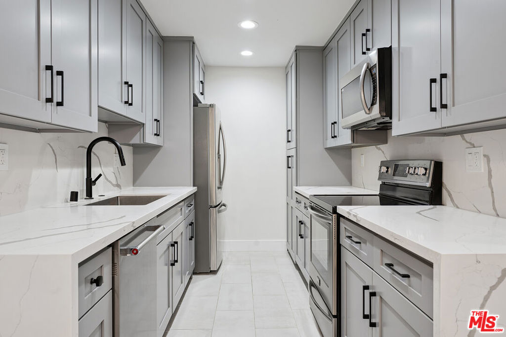 Welcome to this fully remodeled 2BR 2BA first floor unit in the Newcastle Manor Condo Association. This stylish unit features new vinyl plank flooring throughout, recessed lighting throughout, fully updated kitchen with stainless steel appliances and quartz countertops. Primary bedroom with recessed lighting, walk-in closet and updated bathroom. Large guest bedroom with recessed lighting and a wide closet. This unit features one of the buildings 4 extra large covered patios, great for hanging out or gardening. This is one of the larger 2 bedroom floorplans with a large living area that can be set up in multiple ways, great for entertaining. Easy first floor access near the lobby. 2 covered tandem parking spaces. Association amenities include a recently replastered sparkling pool, fitness room, laundry room, gated parking and controlled access.