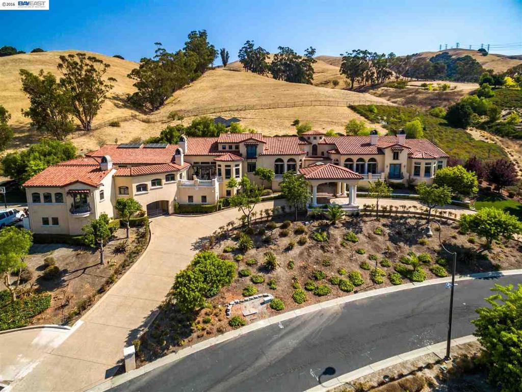 HUGE 1.4 million dollar price slash!! Spectacular home, one of the largest ever offered in Fremont! Exquisitely designed. Nestled on the hills and secluded behind a private gated community. Breathtaking views, solar panels, theater room, library, office, study loft, bonus room/option additional au-pair unit, indoor gym w/ Sauna, indoor pool, elevator, 600 sf in-law suite, 7 car garage, extensive Brazilian cherry wood and marble flooring, absolutely loaded with amenities.