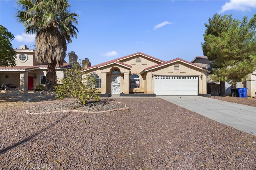 Welcome to 15386 Fremont Dr. Adelanto –Imagine coming home where comfort and peace of mind come together. This home is in a perfect setting for both everyday living and unforgettable moments. This thoughtfully designed 4-bedroom, 2-bathroom home offers 1,640 sq ft of inviting space on an expansive 7200 sq ft lot. Built in 1995, it features nice sized back yard with an inviting patio and shade trees. This home, welcomes you with a cozy fireplace, in the living room/formal dining room while the kitchen impresses with tile floors, a breakfast bar and plenty of cabinets. with lots of room.  Just off the kitchen, a separate family room provides the perfect space to relax, host guests, or enjoy quiet evenings. The indoor laundry room near the kitchen included adds convenience to your daily routine, making chores feel effortless. The nice sized primary suite with a walk-in closet, ceiling fan, private bath area for your own private escape. Additional highlights include a 2-car attached garage, tile roof, and a fully fenced backyard designed for tranquility and entertaining. Just minutes from Highway 395, this home combines peaceful living with commuter convenience. Ready for you to move in and full of charm, this is your opportunity to own a truly special home in the High Desert.