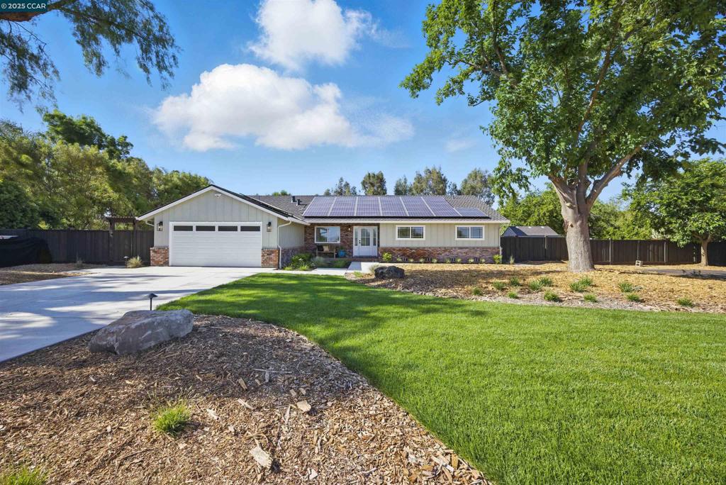 Looking for a beautifully renovated estate in Oakley with a sparkling pool and stunning landscaping? This 2,100 sq ft, 3-bed, 2-bath home checks every box. Enjoy an open-concept layout filled with natural light and serene backyard views. The kitchen shines with custom cabinetry, a large center island, and sleek finishes—ideal for entertaining or everyday living. The living room features a freshly refaced fireplace, new flooring, and fresh paint throughout for a cohesive, modern feel. The primary suite is your peaceful retreat, complete with an ensuite bathroom and sliding glass doors that open to your resort-style yard. Step outside to a newly refinished pool, custom BBQ area, fire pit, lush new landscaping, and ample room to relax or host. Upgrades offer peace of mind, including: new roof, new HVAC, new septic, new propane tank, new well components, new privacy gate, and owned solar. The front yard features fresh landscaping and new concrete, adding to the incredible curb appeal. Plenty of space for RV/boat parking and the potential to add an ADU, workshop, or guest home. This fully remodeled property combines the feel of a new build with the comfort of a private, spacious estate. Welcome home!