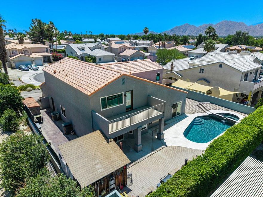 Beautiful, Spacious Home in Desirable Primrose Neighborhood - No HOA! Ideally located in central Palm Desert, this expansive 5-bedroom, 3-bath home offers 3,000 sq ft of comfortable, upgraded living. The open floor plan includes a living room with dual gas/wood-burning fireplace, a formal dining room, and a stunning family room/library featuring a full floor-to-ceiling library --perfect for book lovers. The spacious kitchen boasts granite counters, a breakfast bar, cooktop, oven, and ample cabinetry. The 5th bedroom features a private French door entry, ideal as a guest suite or casita with its own mini-split HVAC unit. The 4th bedroom has access to a full bath. The luxurious master suite includes a beautifully remodeled bath with 2 walk-in shower, soaking tub, dual vanities, 2 walk in closets, and a balcony with breathtaking mountain views. Enjoy outdoor living with multiple seating areas, a remodeled Pebble Tec pool/spa and  BBQ area.Cozy front porch seating area. The 2-car garage and there's a full-sized laundry room with cabinets.Low maintenance Desert Landscape.Upgrades Include:   Newer dual-pane windows  Remodeled bathrooms  Laminate, wood, and tile flooring throughout Newer light fixtures and ceiling fans Newer dishwasher & microwave,  & brand new water heater  Dual HVAC systems + mini split in casita  Newer pool filter.This beautiful home is a rare combination of size, location, and character! A must see home!.