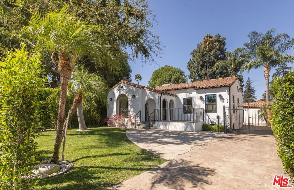 Tucked into the heart of Toluca Lake, this exceptionally private Spanish Revival residence marries architectural heritage with modern sophistication. The home retains its timeless character through elegant arched doorways and bespoke detailing, while seamlessly integrating 21st-century conveniences such as fully digitized climate, lighting, security, and pool systems. A separate ADU expands the estate's versatility, offering an ideal retreat for guests or the perfect setting for a home office. Outdoors, a lushly landscaped backyard reveals a generous pool framed by mature greenery, creating a secluded environment for entertaining or quiet repose. Balancing vintage charm with curated modern updates, this Toluca Lake jewel embodies the rare fusion of character, privacy, an architectural gem in one of Los Angeles' most established neighborhoods. 3 bedrooms 3.5 bath in Main House + ADU with full bath.