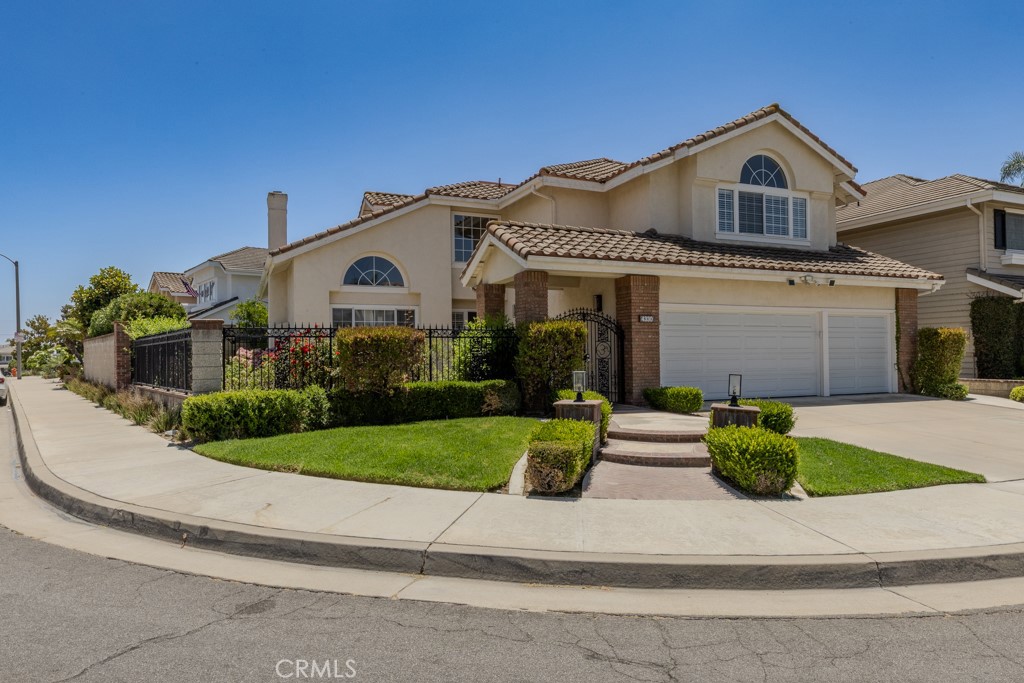 Welcome to this bright, beautiful, move-in-ready home on a sunny corner lot in Belmont Estates. Upon entering the home, you’re welcomed by high ceilings, a stunning chandelier, and an open floor plan with abundant windows that fill the space with natural light. The private living and dining rooms feature elegant hardwood floors and a cozy fireplace, and travertine flooring flows through the main areas for timeless style.
An expansive family room with its own fireplace opens seamlessly to the modern kitchen with quartz countertops, double ovens, a center island, a dining nook, and a premium Bosch cooktop. A stylish bar with a wine fridge and designer backsplash elevates every gathering and is ideal for entertaining. A desirable main floor bedroom provides flexible living for guests or multi-gen needs. Upstairs, the spacious primary suite offers a cozy sitting area and a luxurious en-suite bath with a glass shower, an elegant freestanding soaking tub, dual vanities, and a large walk-in closet. In addition, the second floor also features two large bedrooms and a versatile, oversized bonus room with modern built-ins and a walk-in closet — perfect for an office, media room, or private gym.
Comforts include new contemporary bathrooms, new dual HVAC systems with HEPA filters, a separate laundry room, a new ultra-quiet garage door with a keypad, a new water heater, and a 3-car garage with built-in cabinets and ceiling racks for ample storage.
Step outside to a lush backyard oasis with a new gazebo, multiple outdoor entertaining areas, and lemon, orange, guava, and pomegranate trees that is perfect for relaxing or hosting gatherings.
This corner lot home combines thoughtful upgrades, elegant design, and the peaceful charm of Belmont Estates — ready for you to move in and enjoy!