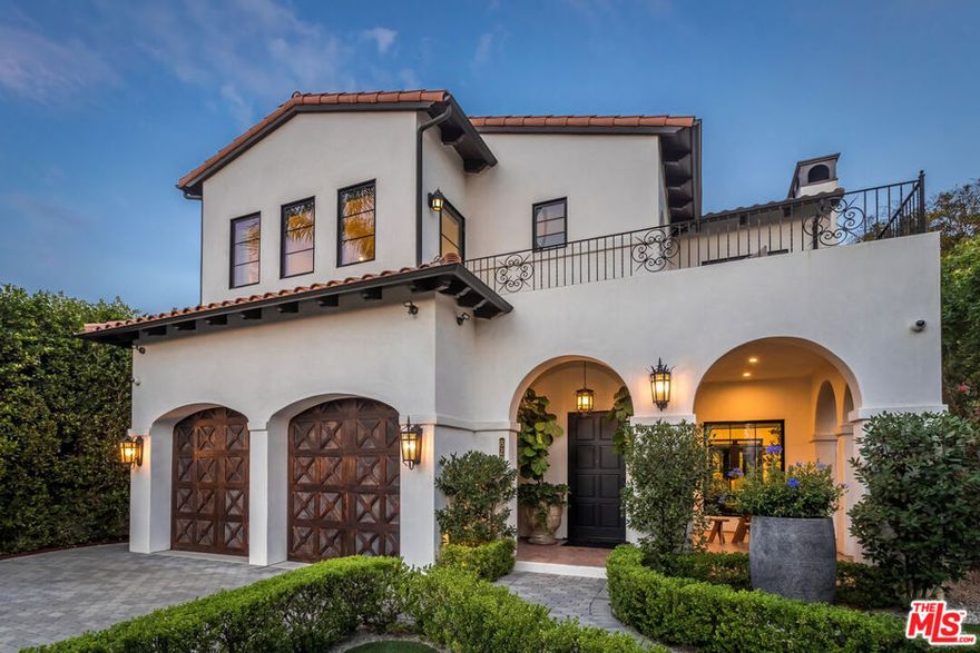 This resort-quality Spanish Revival home is a rare opportunity, blending timeless elegance with modern livability. Fully gated and exceptionally private, the residence is framed by mature palms, lush landscaping, and multiple courtyards, patios, and terraces that create the quintessential California indoor-outdoor lifestyle. Inside, the architecture exudes character with graceful archways, wood-beamed ceilings, and charming wrought iron and tile finishes. The layout is designed for intimate gatherings yet equally suited to large-scale entertaining, with the living, dining, and family rooms wrapping around a tiled interior courtyard with fire pit. Outdoors, a sliding wall of Fleetwood doors connects the home to a private pool, spa, and BBQ area, all surrounded by mature trees and landscaping. The chef's kitchen and primary bath are showcases of custom quality and understated elegance, while a large butler's pantry provides added convenience. Every upstairs bedroom opens to its own terrace, and the thoughtful design continues with a 500 sq. ft. roof deck featuring a built-in wet bar and sweeping 360-degree views of all of Los Angeles. There is simply nothing else on the market with this level of detail, design, and sophistication, while central to the best of West Hollywood and Beverly Hills.