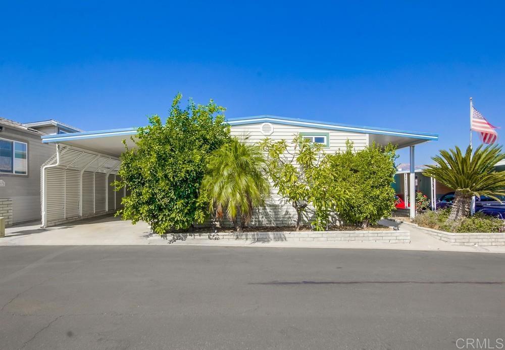 Enjoy your LAKE and MOUNTAIN views from this 2BD 2 BA home located in a 55+ gated community. The large windows with custom shades in the living room to enjoy the view while snuggling up to the cozy corner pellet stove. The center of this home has an island with a gas cooktop providing extra seating and beautiful white kitchen cabinets to complete the kitchen. Family room has a sliding glass door that leads out to the covered front porch with steps leading down to the fully covered patio area, creating your own private outdoor space. Spacious shed provides extra storage or workshop area. Community offers a clubhouse, library, game room with pool tables and card tables, heated pool, dog park and much more. RV parking available. All this with a low monthly HOA fee and no space rent!