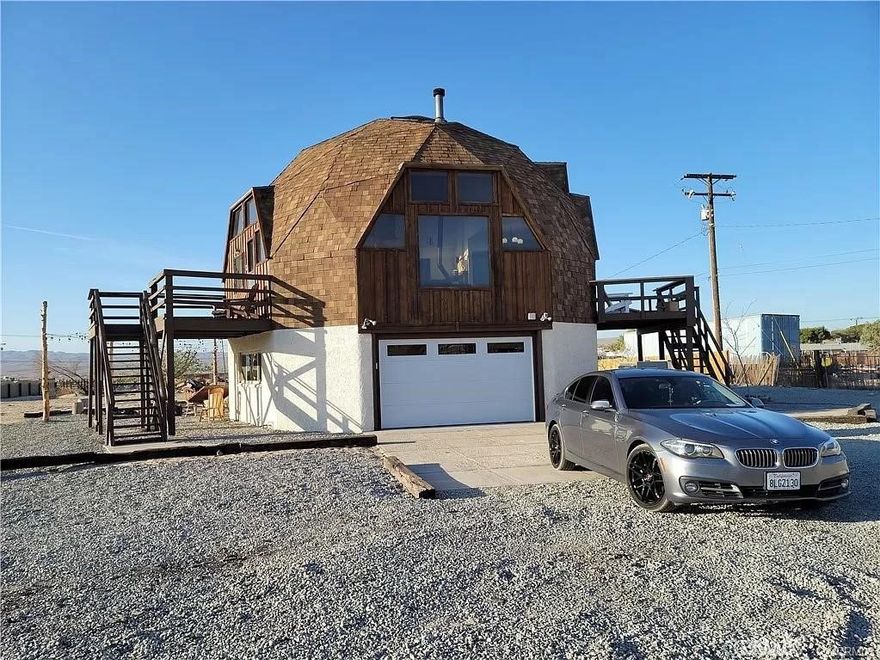 Eccentric Dome House on 5 Sprawling Acres – Fully Remodeled, Furnished, and Airbnb Ready! Discover this truly unique and fully remodeled 3-level Dome House, set on 5 acres of fenced land just outside of town, across from the local drive-in movie theater. Currently operating as a highly successful Airbnb, this one-of-a-kind property was remodeled in 2021, comes fully furnished, and includes a paid city Airbnb license—offering a ready-to-go opportunity for short-term rental or personal use. Key Features: 1st Level: A spacious garage, laundry room, and an additional living area with a studio layout, featuring a kitchen and ¾ bath. This extra 300-400 sq. ft. of space is ideal for guests, making it perfect for rental flexibility or private use. 2nd Level: Two bedrooms, a full bath, and an open-concept kitchen and family room with large plate glass windows that frame stunning mountain views. The kitchen and family room open up to decks, providing plenty of space to relax and enjoy the outdoors. 3rd Level: A private master suite with its own full bath for ultimate seclusion and comfort. Outdoor Living & Amenities: Large rear and side yards covered with ¾ gravel, designed for low maintenance and ideal for outdoor gatherings. String bistro lights, a fire pit, an oversized picnic table, lounge chairs, a BBQ area, and a hot tub create the perfect environment for relaxation and entertaining. Hot tub included—perfect for year-round enjoyment under the stars. Bonus Features: A game room stocked with entertainment options, making this home even more attractive for renters or personal use. Airbnb Ready: This property has been a thriving Airbnb with a paid city license, and the current owner is willing to leave everything in the home—including furniture, appliances, décor, and Airbnb essentials—so it can continue as a turn-key rental. All you need to do is step in and start hosting! Additional Highlights: All three bathrooms feature updated quartz countertops while preserving the original character of the home. The owner is offering to leave everything as-is, making it a seamless investment for short-term rentals or a beautifully furnished private retreat. With its unique architecture, fully furnished setup, and proven success as an Airbnb, this Dome House offers a rare opportunity for investors or those seeking a distinctive personal getaway. Don't miss out on this one-of-a-kind property!