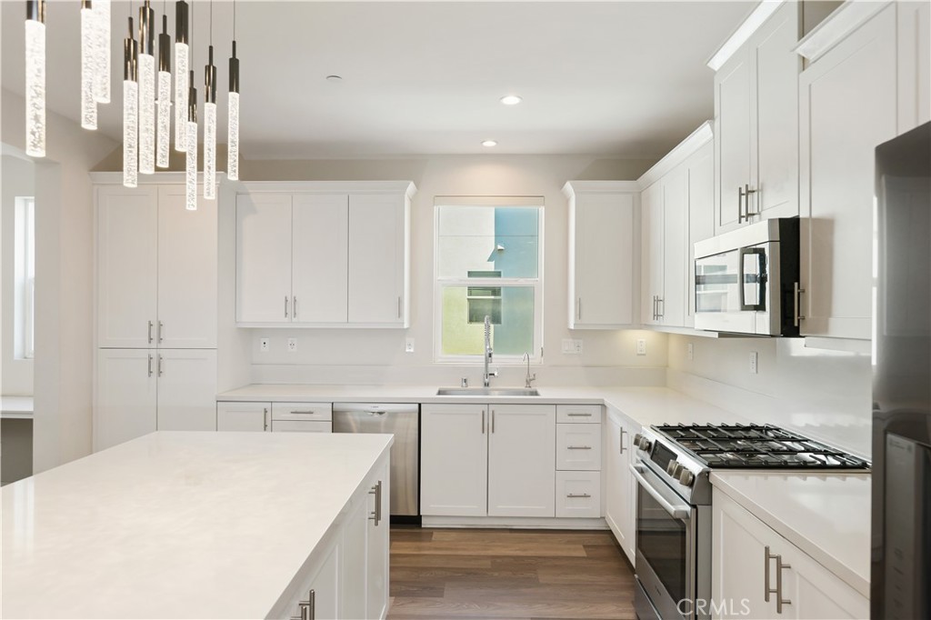 Welcome to 2238 Synergy, located in the highly desirable C2E community of Irvine. This modern three-story home features a thoughtful layout: a private suite and attached garage with a Tesla charging station on the first floor, a spacious kitchen and living area on the second floor, and two additional suites on the third floor. The home offers abundant natural light, comfortable living spaces, a gourmet kitchen with stainless steel appliances and ample storage, whole-house water softener, and direct drinking water from the kitchen. Residents enjoy a community swimming pool. Conveniently located near Irvine Business Complex and just a three-minute drive to Diamond Jamboree Plaza and H Mart, with easy access to shopping, dining, entertainment and major freeways, this home combines comfort, convenience, and luxury.