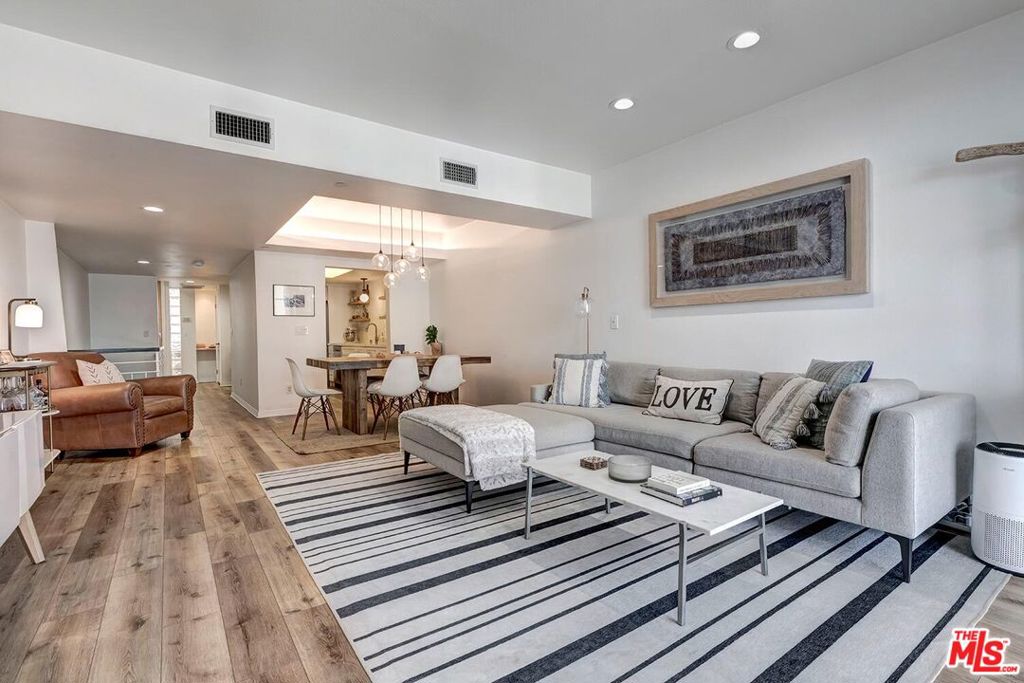 Welcome to this beautiful updated townhouse with two spacious bedrooms and three bathrooms. The open layout in the living and dining areas features coffered ceilings, beautiful hardwood floors and floor to ceiling windows that fill the space with natural light and showcase sweeping views of the Bel Air hills, treetops, and city lights. The remodeled kitchen is both stylish and functional, with quartz countertops, custom cabinetry, floating shelves, and modern appliances. Downstairs, you'll find two generously sized bedrooms, each with its own en-suite bathroom. The primary suite includes a walk-in closet, and the laundry area is conveniently located between both bedrooms. The community offers great amenities, including a heated pool, fitness center, and dry sauna. Other features include two individual parking spaces, plenty of guest parking, and secure gated entry with 24-hour camera surveillance. Located close to Brentwood shops and restaurants, UCLA, and zoned for Kenter Canyon Elementary, this home offers comfort, convenience, and a great Westside location.
