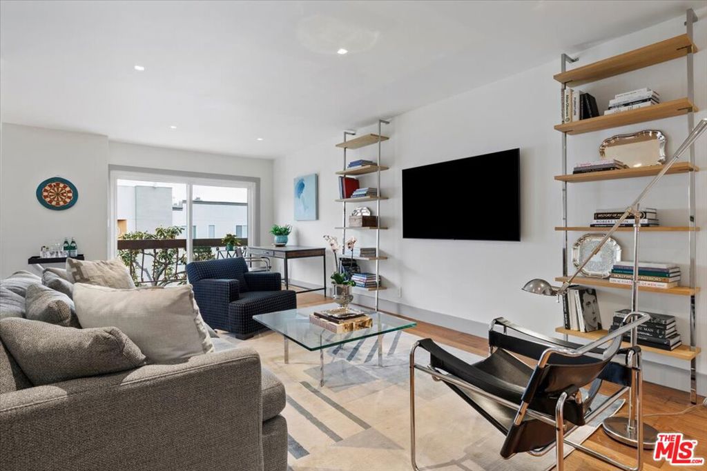 Welcome to this beautifully reimagined one bedroom condo, nestled in the coveted Hollywood Hills. Spanning 831 square feet, this top floor, east facing residence has been completely renovated to combine modern luxury with timeless design. Step inside to discover warm oak flooring, custom paneled doors and millwork throughout. The bright sun filled space is enhanced by trimless LED lighting and WiFi-enabled Lutron smart switches for effortless ambiance control. The all new kitchen boasts custom soft close cabinetry, a Bosch paneled dishwasher, GE smart range and refrigerator with built-in ice maker, and satin brass fixtures. A stunning quartzite countertop and handcrafted tiles from the Pacific Northwest add a touch of artisan charm. The sophisticated bathroom is outfitted with a marble countertop, Kohler soaking tub shower, and Moen fixtures. The in-unit Samsung washer and dryer provide added convenience. The generously sized, light-filled bedroom includes a walk-in closet, plus there is large hall closet for ample storage. This pet-friendly, low-rise building offers a host of amenities including a barbecue area, gym, pool, sauna, and a common media/recreation room. The brand new elevator provides easy access to the unit from the two tandem parking spaces located near the elevator lobby in the secure garage. Located just moments from Runyon Canyon, the Sunset Strip, and the vibrant dining, nightlife, and shopping scenes of Hollywood and West Hollywood, this pristine condo is the perfect blend of comfort, sophistication, and location. Every detail has been thoughtfully considered - welcome home!