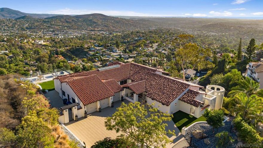 Breathtaking views. Endless sunsets. Absolute tranquility.  Welcome to 9775 Alto Drive—where modern luxury meets the timeless beauty of Mt. Helix living.  From the moment you arrive, you’re greeted by breathtaking views stretching from the rolling hills of Mt. Helix to downtown San Diego, with shimmering ocean views glinting on the horizon. Every room offers a new perspective—each more captivating than the last.  Completely reimagined by the owner, this residence reflects a perfect balance of sophistication and comfort. Rich hardwood floors, marble-clad spa-inspired baths, and an open, airy floor plan invite the outdoors in. Designed for both everyday living and grand entertaining, the home features a custom wine room, a stylish entertainment lounge, and a private theater room for unforgettable nights in.  Step out onto the expansive deck and take in the panoramic skyline, the ocean breeze, and the golden glow of San Diego sunsets. The gated drive and elegant approach leads to a sanctuary that feels both glamorous and grounding—a true retreat above it all.  Experience the beauty, privacy, and sophistication of this Mt. Helix masterpiece- crafted for those who appreciate elevated living at its finest.