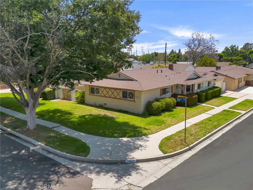Set on a prominent corner lot in a sought-after Northridge neighborhood, this inviting single-story home offers over 2,100 square feet of comfortable living space on a lot of approximately 7,500 square feet. With 4 generously sized bedrooms and 2 baths, the layout is functional and full of promise for future customization. The formal living room showcases a classic stone fireplace tucked into the corner, lending character and warmth. The kitchen provides a central hub and connects to a formal dining room that opens directly to the backyard through sliding glass doors—ideal for hosting gatherings. Adjacent to the dining area, a sunken family room features dramatic wood-beamed cathedral ceilings and a second set of sliding doors, enhancing indoor-outdoor flow. A laundry room is conveniently located off the kitchen with access to the side yard. The primary suite includes its own 3/4 bath, while the secondary bedrooms share a well-appointed full hallway bathroom. An attached 2-car garage offers additional room for storage. Outside, a large, covered patio anchors the backyard, with ample open space for entertaining, play, or gardening. With a little vision, there’s potential to open up the floorplan and transform this lovingly cared-for home into a modern masterpiece. Located within the boundaries of well-regarded Calahan Street Elementary and Grover Cleveland Charter High School, the home is also moments from major conveniences like Costco, Whole Foods, and Target, and is near Northridge Fashion Center for retail and dining. Local recreational options abound with nearby Dearborn Park and scenic hiking at Limekiln Canyon, and commuters will appreciate easy access to the 118 and 405 freeways, connecting you effortlessly to all corners of the Valley and beyond.