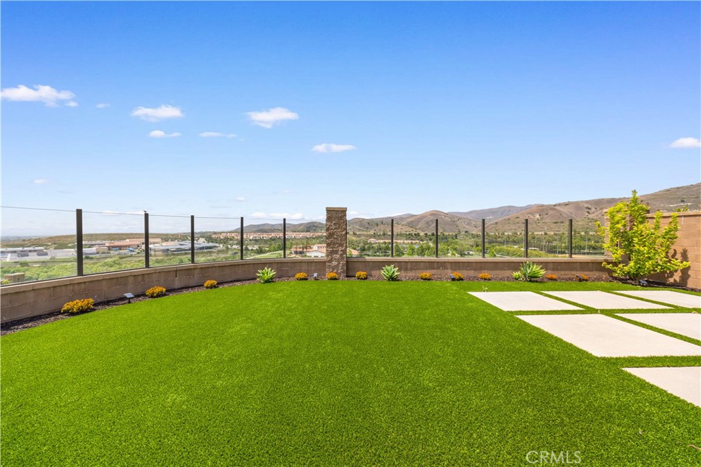 View!View!City View home! Cornet lot!This stunning 3-bedroom, 2.5-bathroom home offers a modern, comfortable living experience. The elegant foyer leads to a spacious living area with panoramic sliding doors that open to a generously sized backyard, perfect for outdoor activities. The gourmet kitchen features stainless-steel appliances, a custom backsplash, a 6-burner cooktop, and a large center island with a breakfast bar. Upstairs, the serene master suite includes a walk-in closet and a deluxe ensuite bathroom with dual vanities, a soaking tub, and a separate shower. Two additional bedrooms and a full bathroom provide ample space for the family. Convenience is key with a dedicated laundry room, a powder room on the first floor, and an attached two-car garage. High ceilings throughout the home create an airy and open atmosphere. The community offers access to the Irvine School District, easy highway access, nearby parks, and community pool. Don’t miss the opportunity to own this best view home in Portola Springs!