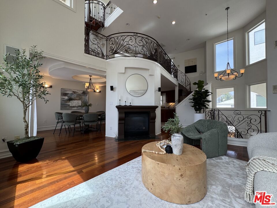 Experience the pinnacle of Santa Monica living in 2025 with this luxurious townhome, ideally located between the vibrant 3rd Street Promenade and chic Montana Avenue, just moments from the Pacific Ocean. This 3-bedroom plus loft, 3-bath townhouse boasts a dramatic, light-filled living room with 20+ foot ceilings, a double-sided fireplace, and a state-of-the-art surround sound system. The recently reimagined chef's kitchen features top-tier stainless steel appliances and Travertine counters, perfect for entertaining. Enjoy Brazilian cherrywood floors throughout, an expansive loft/den with balconies, and a private top-floor oasis leading to a private terrace with Santa Monica city line views. The master suite offers a beautifully remodeled bath with a walk-in rainfall shower and freestanding soaking tub. Convenience is key with a direct-access, EV-ready two side by side car garage, guest parking, and ample smart storage. Embrace unparalleled walkability to beaches, shops, Michelin-starred restaurants, and the vibrant Wednesday and Saturday farmers markets. The home is situated in the Santa Monica-Malibu Unified School District in the Roosevelt elementary zone. This is more than a home; it's a lifestyle.