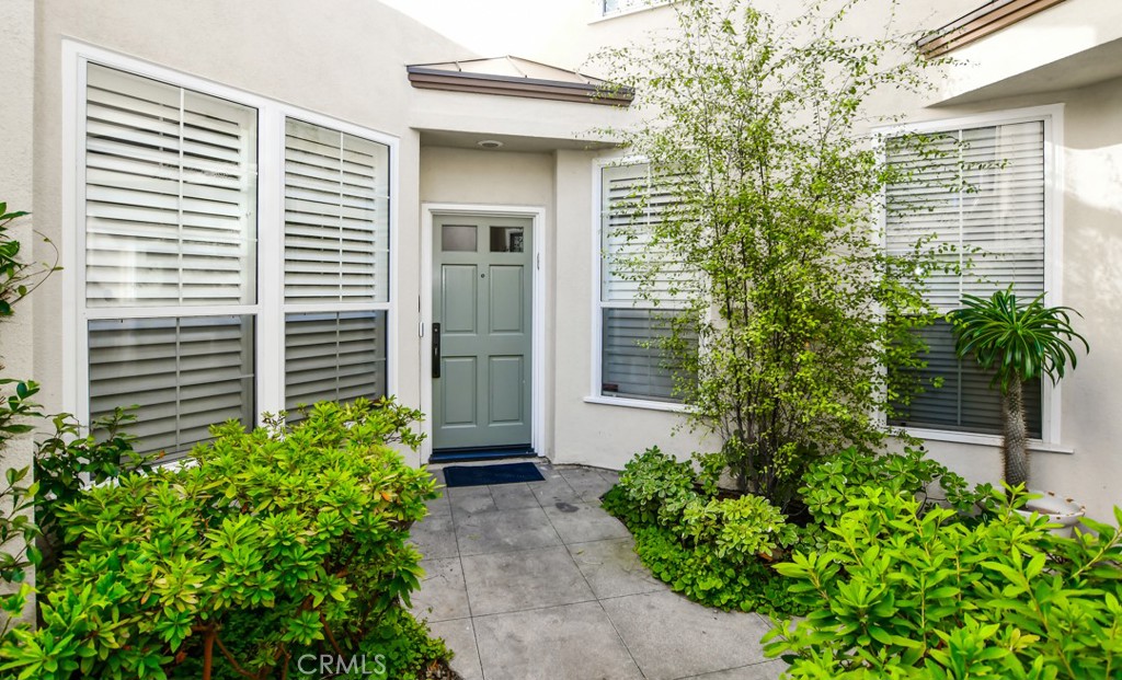 Behind the gates of The Summit in Newport Coast, this luxurious townhome has a view of the trees and hills in Newport Coast. Highly upgraded throughout this home encompasses three-bedrooms (including one on main level) three-baths with 20 foot plus ceilings, it is open and inviting. The entry foyer leads to a formal living room, dining room with a double-sided fireplace, leading out to the private slate covered backyard patio. This home showcases solid hardwood wood flooring throughout with oversized plantation shutters. Enjoy a chef-inspired kitchen with custom shaker white cabinetry, quartz countertops, a full glass tile backsplash, and high-end stainless - steel appliances. A fully finished garage includes built-in storage and epoxy flooring. Upstairs, the luxurious primary suite awaits with a spacious room and adjoining master bath complete with expanded master shower with statutory marble full slab walls, double shower head, quartz counter tops and flooring. Beautiful! Custom built-ins in the spacious master closet. All baths have been remodeled with quartz showers, counters and floors. Close to Crystal Cove, Fashion Island, parks and trails. Your coastal lifestyle awaits!