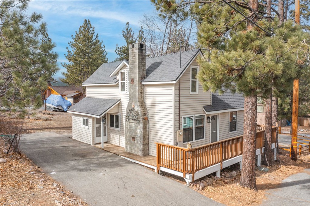 Just minutes from The Village, Boulder Bay Park, the boat launch, and the Alpine Slide, this beautifully updated Big Bear cabin offers the ideal blend of mountain charm and modern convenience. Step inside to find thoughtful upgrades throughout—including sleek flooring, plush carpet, recessed lighting, and updated appliances. The inviting living area features a classic Big Bear rock fireplace, perfect for cozy evenings, while the stylishly remodeled bathroom boasts a glass walk-in shower. The updated kitchen shines with butcher block countertops and new fixtures, bringing functionality and warmth together seamlessly. Upstairs, a spacious bedroom easily fits a queen and two twin beds, with a second bathroom offering added convenience. A large finished attic provides excellent storage for skis, seasonal gear, or kids’ toys. Stay comfortable all year long with a newer downstairs wall heater and a separate upstairs unit. The roof was replaced in August 2023, and additional perks include a tankless water heater and a wood storage shed in the backyard. Outside, the long asphalt driveway fits 2–3 cars and offers direct access to the backyard—ideal for RV or boat parking. Whether you're looking for a cozy getaway or a year-round retreat, this cabin delivers comfort, location, and Big Bear charm in every season.
