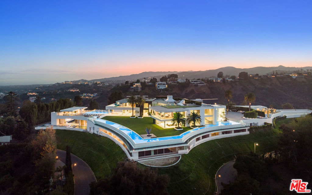 AUCTION: Bid Feb 28 - Mar 3. Listed for $295M. Representative Onsite Daily. Can be sold before the auction. The One is an exclusive masterpiece that redefines luxury. The 105,000sf work of art floats above the city of L.A., elevated for maximum panoramic views. 10 years in the making, The One is the largest & grandest house ever built in the urban world. A home of this magnitude will never again be built in L.A., cementing it in a class of its own. 360-degree views of the Pacific Ocean, Downtown L.A., & San Gabriel Mountains await. Every imaginable amenity creates incomparable comfort & appeal: 5 pools, a massive nightclub, full-service salon & spa, 10,000sf sky deck, 400ft private outdoor running track, & private Dolby Digital theater seating 40+ barely skim the list. Each room is decorated with a neutral palette paying homage to the stunning landscape, keeping the estate cohesive despite its staggering scale. The first & last of its kind, The One allows you to experience L.A. beyond your wildest dreams.