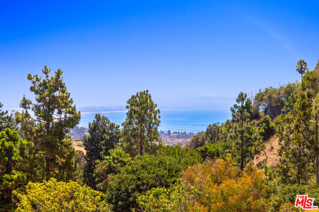 A rare and remarkable opportunity in one of the Palisades' most coveted cul-de-sacs, untouched by recent fires. This charming Traditional sits on a beautiful tree-lined street and offers ocean views, serene surroundings, and endless potential to enjoy as-is, expand, or fully reimagine. Inside, natural light fills the spacious open floor plan, accented by hardwood floors, wood-beamed ceilings, a cozy fireplace, and French doors that create a seamless indoor/outdoor flow. The recently remodeled kitchen features crisp white cabinetry, subway tile backsplash, granite countertops, and a new oven and cooktop. Upstairs, the large primary suite boasts a beautifully updated bath, generous walk-in closet, ocean views, joined by two additional bedrooms. Outside, an expansive covered patio and inviting deck provide the perfect backdrop for entertaining or simply soaking in the coastal breezes. Moments from the heart of the Palisades yet tucked away in a tranquil cul-de-sac, this is a rare chance to own in a premier location with endless possibilities.