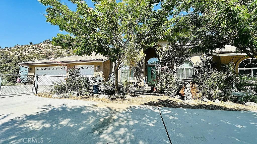 This stunning 4 bedroom, 3 bathroom home offers an expansive open floorplan. With approximately 2600 sq. ft. of living space, you will find comfort and style in every corner. There is so much to see here so take your time and explore this amazing property. The driveway leads to a 3 car attached garage, room for RV parking on the northern side of the house (and pretty much everywhere else on the sprawling 2.16 acre lot). The side entrance door to the garage makes loading and unloading the RV a breeze. The property is fenced with the front yard fenced off and vinyl fencing in the back yard. The horse area is fully fenced and features a privacy fence on the southern edge of the property. The arena is graded and features heavy duty arena railing. There are two separate horse corrals with covered shelters. A stand alone shed for horse feed and tack adds a touch of convenience. The custom tree house is a wonderful place to unwind. No need to go to the gym with this property, there are running trails throughout and the lot even features a hill to run up and down for the ultimate workout. The inside of the home offers a wonderful floorplan with 4 bedrooms and 3 full bathrooms. The entry way has ample space leading to the open family/great room that is open to the large kitchen. There is a formal dining and living room adjacent to the entryway. The kitchen features neutral color tile countertops, built in oven, 4 burner cooktop and overhead microwave. There is a large island in the center of the kitchen. One of the best features is the large countertop with room for barstools that adds space, convenience, and entertainment value to the kitchen. There is a large pantry and plenty of countertop space with ample storage.
The Master Suite is large and spacious with double door entry, the master bathroom features dual vanity, large walk in shower, large soaking tub, and a walk in closet. One awesome feature is the private entrance to the backyard with the luxurious swim spa just steps away!
Bedroom 2 has a separate entrance to the covered back patio, features a separate bathroom and laminate flooring . Bedrooms 3 & 4 are adjacent to each other and share bathroom #3.
Built by Desert Star homes in 2007 the floorplan was their most popular and offers a really cool place for daily living and bringing everyone together. Everything flows naturally as there is no wasted space. Mature landscaping, swim spa, covered patio, extensive hardscape, fireplace with wood burner.
