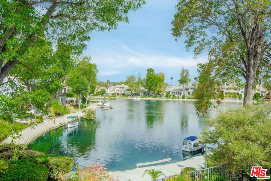 Experience stunning lake views from nearly every room in this beautiful lakefront home! Nestled on a cul-de-sac, this bright and airy 3-bedroom, 3-bath home boasts over 2,700 square feet of open living space. Extensively remodeled and move-in ready! As you enter, you'll be captivated by the lake views in the spacious living room, which features high ceilings, double doors leading to a large outdoor deck, and a  fireplace. The modern kitchen includes an oversized wood island, brand-new stainless steel appliances, a walk-in pantry, and convenient access to the deck-perfect for enjoying your morning coffee while taking in the vibrant lake scenery. The room on the main level can be used as either a bedroom or den, offering plenty of closet space and direct access to the front porch. The primary bedroom, located on the lower level, features a fireplace, direct access to the patio, and two private walk-in closets with built-ins.  An additional room on this level, perfect for a gym or yoga studio, offers you the freedom to personalize your space. The top floor features a versatile loft that can adapt to your needs, whether it's an additional bedroom or productive office complete with a built-in desk, ample storage closet, and a bathroom with a shower. The outdoor patio space is perfect for entertaining and relaxing, and you're  just steps away from the lakes walking path- the loveliest walk around! This property also includes a generously sized two-car garage with storage racks and an additional storage room. The Homeowners Association (HOA) grants access to Calabasas Lake and provides 24/7 vehicle patrol throughout Calabasas Park. All this is located in the award-winning Las Virgenes School District and in close proximity to the bustling Calabasas Commons and the Calabasas Tennis and Swim Club, offering a lifestyle of convenience and leisure.