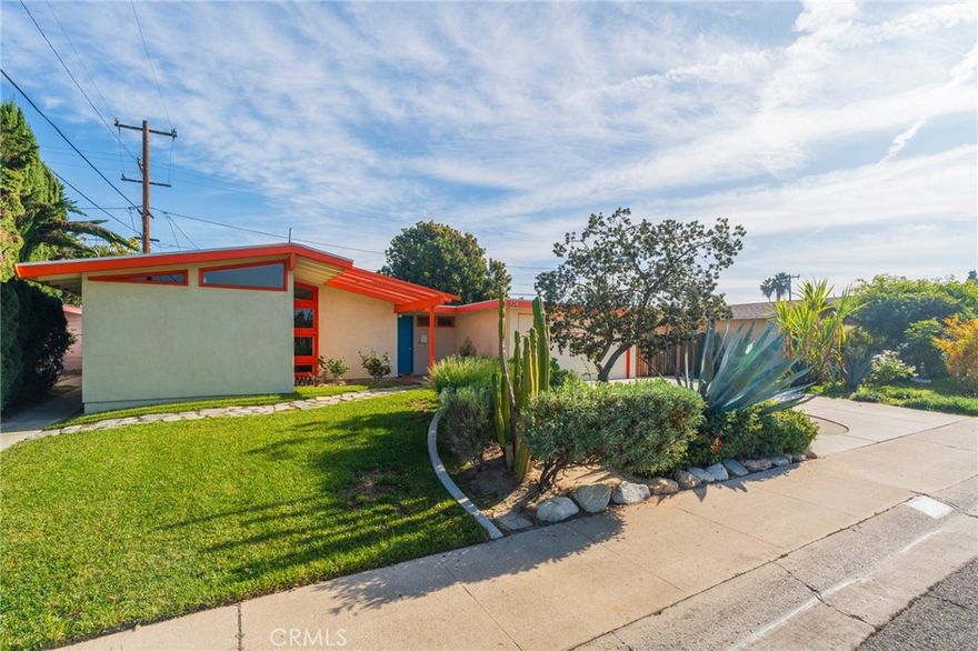 Discover a rare piece of Anaheim history at 934 North Maple Street. This absolutely stunning mid-century home, featuring 3 bedrooms and 1.5 bathrooms across 1,149 sq ft, has been lovingly owned and cared for by the same owner for 42 years. Originally built in 1953 by the renowned Ivan Wells & Son, a firm famous for constructing homes for movie stars in Hollywood and Beverly Hills, this residence offers unique provenance. It boasts beautiful curb appeal and an extra-large driveway with generous parking for extra vehicles, an RV, or a boat. Upon entering, you are greeted by a large formal entry with an office alcove and an insulated sliding door leading to the covered rear patio. The centerpiece is the living room, featuring a dramatic vaulted beam ceiling and floor-to-ceiling corner windows. The home flows seamlessly into a formal dining room and a functional kitchen with custom real maple wood cabinets, a gas stove, solid surface countertops, and ample storage. A permitted addition enhances functionality with an indoor laundry room and a half bath. For comfort, all three bedrooms are perfectly sized, and the entire house features individual ductless heating and air conditioning units for superior energy efficiency. The layout is perfect for entertaining, with direct access to a very large covered patio and a sprawling backyard complete with a mature macadamia tree. Don't miss this opportunity to own a unique Anaheim gem!