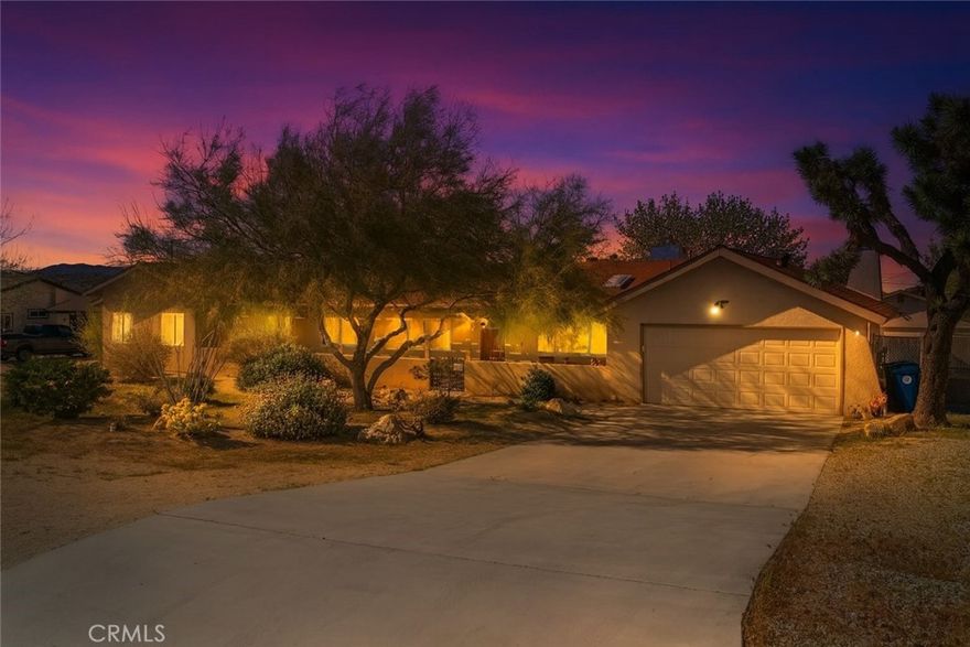Welcome to the desirable Sky Harbor neighborhood! This beautifully maintained home blends charm, functionality, and income potential. Step inside to a warm, inviting living room anchored by a cozy fireplace and timeless Saltillo tile floors. The kitchen features a raw edge countertop, perfect for cooking and entertaining.

A true standout is the attached guest house/ADU/casita with its own entrance, fenced yard, living area, bathroom, and back patio—ideal for multigenerational living or rental income.

The property also includes a massive secondary detached garage (approximately 30'x30') with a new window, offering endless options for storage, a home studio, hobby space, or potential conversion to add an ADU. The oversized lot provides ample RV parking on both sides, fully fenced, with mature landscaping, and room to add a pool.

Enjoy being just minutes from hiking trails at Joshua Tree National Park, Essig Park/dog park, while still close to town conveniences like restaurants, grocery stores, and Walmart.

This home truly has it all: versatility, space, and location. Live in one, rent the other, and make the most of the possibilities!