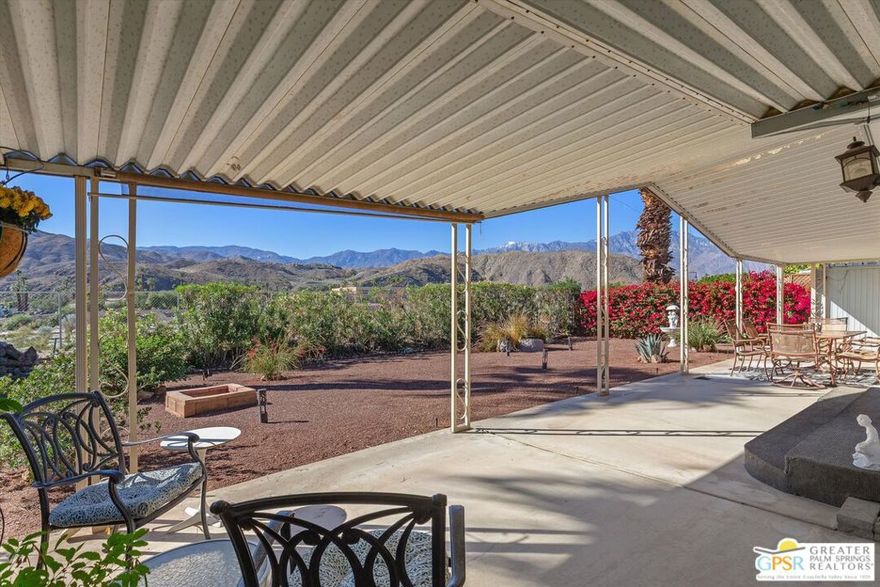 Embraced by a beautiful oversized homesite that backs to natural open space and no other residences, this inviting manufactured home offers stunning mountain views. Located near the end of a cul-de-sac in Cathedral City's guard-gated Date Palm Country Club, the single-level design is perfectly positioned to take full advantage of panoramic views that extend from Mount San Jacinto to the Santa Rosa Mountains in the south. A meticulously maintained and fully fenced yard wraps around three sides of the home, offering sun and shade spaces that are ideal for entertaining, kicking back or simply taking in the spectacular views. Vaulted and beamed ceilings enhance the open ambiance of the interior, which measures approximately 1,560 square feet and features two bedrooms, two baths, and brand-new wide-plank laminate flooring throughout. Floor-to-ceiling windows bathe the living and dining rooms in an abundance of natural light, and the family room opens to the patio and an impressively updated kitchen. Enjoy an island with seating, granite countertops, full tile backsplash, a suite of stainless steel Frigidaire appliances, contemporary high-gloss cabinetry, a built-in pantry and a pass-thru to the dining room. Mirrored wardrobe doors enhance both bedrooms, including a spacious primary suite with built-ins, an ensuite bath with two sinks, mountain views and direct access to the rear patio. A big advantage, rooftop solar panels cover electric bills. Catering to the active lifestyles of home buyers 55 and better, the resort-caliber Date Palm Country Club reveals a gorgeous 18-hole golf course, full-featured pro shop, newly remodeled luxury clubhouse, a popular restaurant, three pools and spas, tennis and pickleball courts, a fitness center, dog park, library/meeting room, verdant greenbelts and sparkling lakes. The theaters, restaurants, shops and park in Cathedral City's revitalized downtown are only minutes away, and Palm Springs and Rancho Mirage provide a broad spectrum of world-famous destinations.