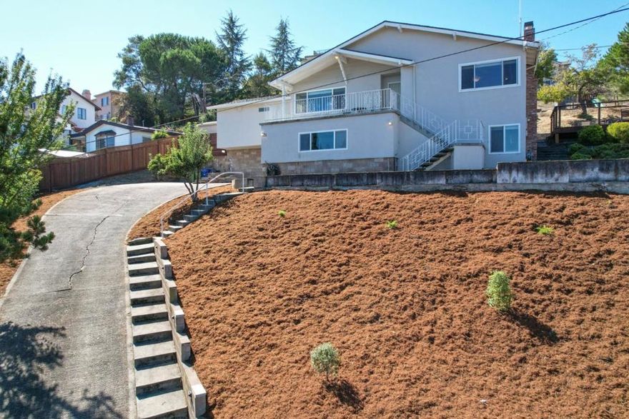 Welcome to this charming Castro Valley home! This 1,758 sq. ft. residence features 3 bedrooms, including a spacious primary suite, and 2 updated bathrooms. As you enter, you will find a large formal family room and a separate living room with a fireplace and hardwood floors throughout. The kitchen offers granite countertops, a stainless-steel refrigerator and dishwasher, and a gas stove. Both the primary and hall bathrooms feature granite vanities and tile floors. Additional highlights include a dedicated laundry room, central heating, and cooling. The home also boasts a versatile bonus area of (255 sq ft),(not included in the homes sq. ft.), perfect for a hobby room, gym, or additional storage. Outside, enjoy beautiful panoramic views, planter boxes for gardening, and a children's play structure. This property is served by highly regarded schools: Chabot Elementary, Creekside Middle, and Castro Valley High.